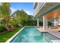 Relaxing pool area with lounge chairs and a grassy area at 2203 Avenue B, Bradenton Beach, FL 34217