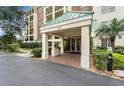 Condo building entrance with covered walkway and landscaping at 1002 S Harbour Island Blvd # 1502, Tampa, FL 33602