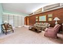 Spacious living room with brick accent wall and vintage furniture at 11012 N Oregon Ave, Tampa, FL 33612