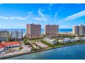 Aerial perspective showcasing beachfront property with waterway at 1310 Gulf Blvd # 4-G, Clearwater, FL 33767