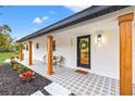 Welcoming front entrance with modern door and wood columns, showcasing updated design at 1400 Farragut Dr, St Petersburg, FL 33710