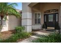 Front entrance with a charming walkway and landscaping at 16809 Woburn Ln, Lutz, FL 33549