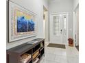 Bright entryway with console table and large artwork at 2721 Tarragona Way, Wesley Chapel, FL 33543