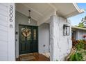 Inviting entryway with a black front door and stone pillars at 3006 Mockingbird Ct, Clearwater, FL 33762