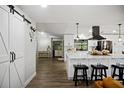 Modern kitchen with white cabinets, quartz countertops, and a large island at 3006 Mockingbird Ct, Clearwater, FL 33762