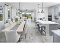 Open concept dining area with view into the living room and kitchen at 31394 Pendleton Landing Cir, Wesley Chapel, FL 33545