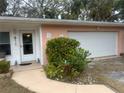 Front door entrance with walkway, landscaping, and attached garage at 3230 San Bernadino St, Clearwater, FL 33759