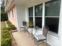 Small patio area with a table and chairs near the home's entrance at 3230 San Bernadino St, Clearwater, FL 33759