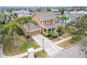 Attractive two-story house with a large yard and palm trees at 402 Islebay Dr, Apollo Beach, FL 33572