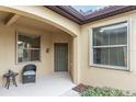 Covered entryway with green door and wicker chair at 430 Cedar Falls Dr, Apollo Beach, FL 33572