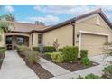 Tan one-story villa with walkway and manicured hedges at 430 Cedar Falls Dr, Apollo Beach, FL 33572