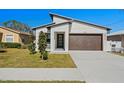 Modern house exterior with a brown garage door and landscaping, creating curb appeal at 4351 56Th N Ave, St Petersburg, FL 33714