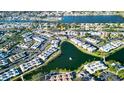 Aerial view showing condo location in a community near a lake at 4361 Tahitian Gardens Cir # C, Holiday, FL 34691