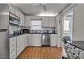 White kitchen with stainless steel appliances and granite countertops at 4650 Cove Cir # 509, St Petersburg, FL 33708