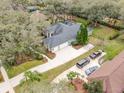 Spacious home with a large backyard, a three-car garage, and a long driveway at 6017 Hammock Hill Ave, Lithia, FL 33547