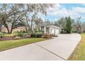 Single-story house with a two-car garage and well-manicured landscaping at 6017 Hammock Hill Ave, Lithia, FL 33547