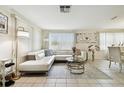 Bright living room featuring a white sectional sofa and large windows at 6040 Antrim St, New Port Richey, FL 34653