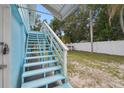 Light blue stairs leading to the back deck at 6416 Finance Ave, Weeki Wachee, FL 34607