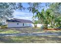 Landscaped backyard with tropical plants and a white fence at 7136 Colony Pointe Dr, Riverview, FL 33578