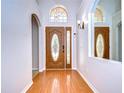 Elegant entryway with hardwood floors, arched doorways, and stained glass at 7136 Colony Pointe Dr, Riverview, FL 33578