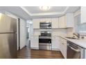 Renovated kitchen, featuring stainless steel appliances and white shaker cabinets at 7930 Datura Lane Ln, New Port Richey, FL 34653