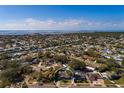 Picture of neighborhood with waterfront views; home has driveway, lush foliage, and classic design at 8307 Boxwood Dr, Tampa, FL 33615