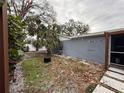 Backyard with gravel, string lights, and some landscaping at 8307 Boxwood Dr, Tampa, FL 33615