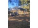 Backyard with a chain link dog kennel and a large plastic dog crate at 8328 Clermont St, Tampa, FL 33637