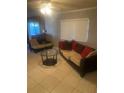 Living room with two sofas, a coffee table, and a ceiling fan at 8328 Clermont St, Tampa, FL 33637