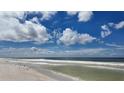 Expansive beach with ocean waves and blue sky at 8581 W Gulf Blvd, Treasure Island, FL 33706