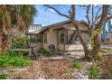 Quaint cottage with screened porch and mature trees at 8581 W Gulf Blvd, Treasure Island, FL 33706