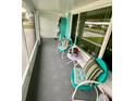 Cozy screened porch with teal chairs and a small table at 9920 34Th N Way, Pinellas Park, FL 33782