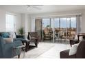 Bright living room with balcony access and city views at 10355 Paradise Blvd # 212, Treasure Island, FL 33706