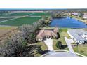 Aerial view of a home with pool, situated on a large lot near a lake and farmland at 10929 Brooksnest Ct, Lithia, FL 33547