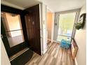 Condo entryway with door, storage and wood-look floors at 1400 Tarpon Woods Blvd # H6, Palm Harbor, FL 34685