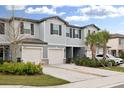 Two-story townhome with attached garage and landscaping at 21428 Darter Rd, Land O Lakes, FL 34638