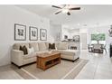 Open living room with L-shaped sofa and access to kitchen and dining areas at 21428 Darter Rd, Land O Lakes, FL 34638