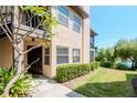 Ground level view of condo building exterior with walkway and landscaping at 2400 Feather Sound Dr # 1418, Clearwater, FL 33762