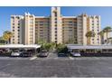 High-rise building with covered parking and landscaping at 2621 Cove Cay Dr # 205, Clearwater, FL 33760