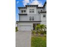 Charming three-story townhome offers a well-manicured lawn, complemented by a paved driveway leading to a spacious two-car garage at 3027 Bermuda Sloop Cir, Ruskin, FL 33570