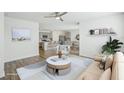 Open living room featuring a neutral color palette, stylish furniture, and a view into the kitchen at 31814 Oyster Trellis Ln, Wesley Chapel, FL 33545