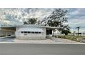 Front view of a charming manufactured home with carport and stone accents at 34212 Canal N Dr # B, Pinellas Park, FL 33781