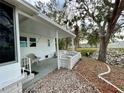 Covered patio with stone flooring and seating area, adjacent to a retaining wall at 34212 Canal N Dr # B, Pinellas Park, FL 33781