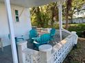 Relaxing patio with teal chairs and a view of the surrounding trees at 34212 Canal N Dr # B, Pinellas Park, FL 33781