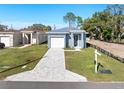 Aerial view of a new gray house with a white garage and paved driveway at 3515 55Th Ave N, St Petersburg, FL 33714