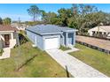 New house with gray siding, white garage door, and a stone driveway at 3515 55Th Ave N, St Petersburg, FL 33714