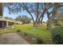 Spacious backyard with golf course view and mature trees at 3624 Muirfield Ct, New Port Richey, FL 34655