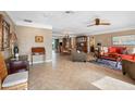 Bright living room with tile floors, ceiling fan, and comfortable seating at 5166 39Th S St, St Petersburg, FL 33711