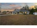 Gray house with a two-car garage, front porch, and a yard at 6069 Newmark St, Spring Hill, FL 34606
