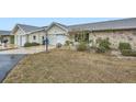 Two-unit exterior view, showcasing stone and garage at 1207 Eastloch Ct, Sun City Center, FL 33573